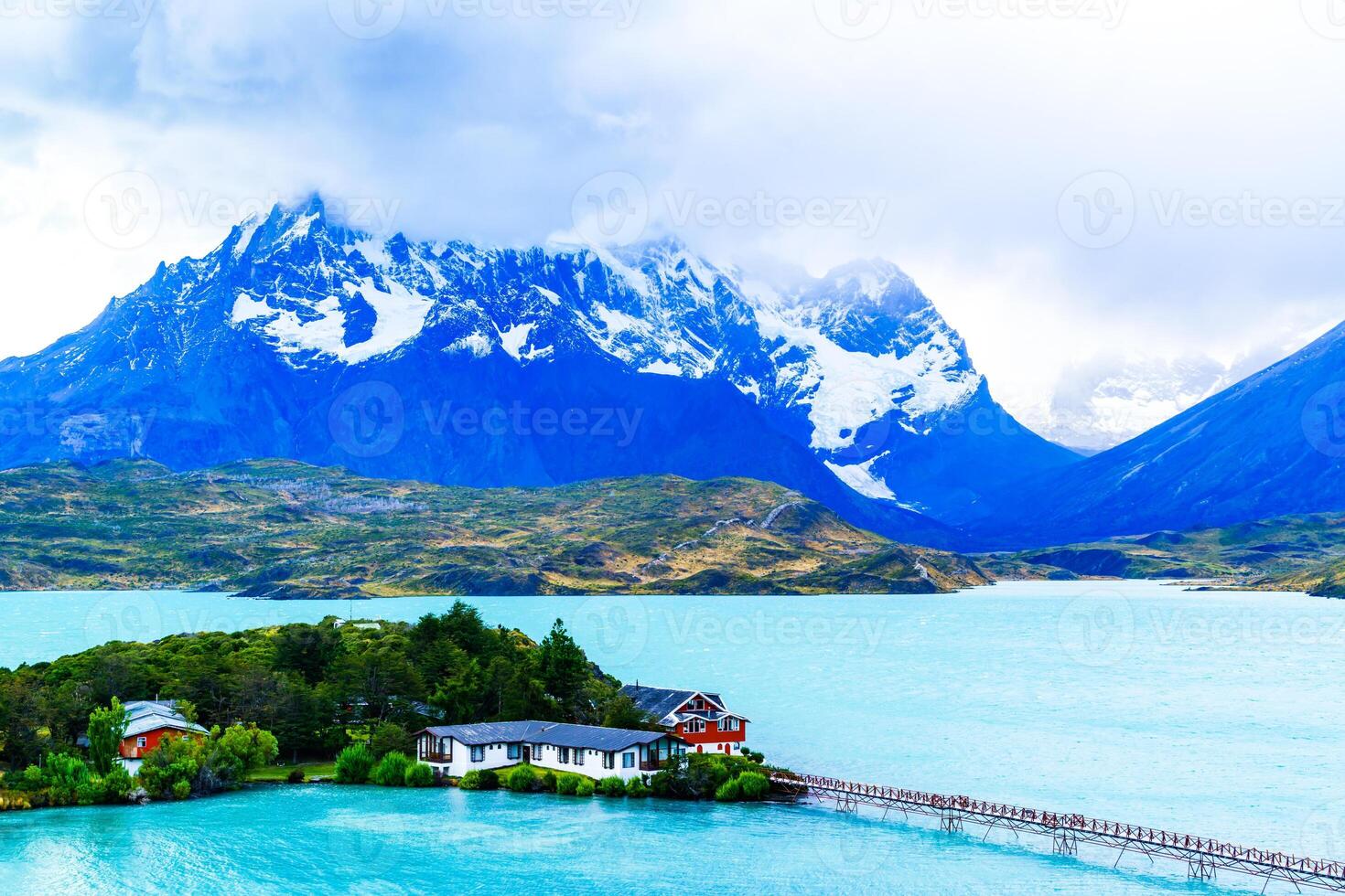 View of Cuernos Del Paine covered with rain clouds and Lake Pehoe in Torres Del Paine National Park. Chile. photo