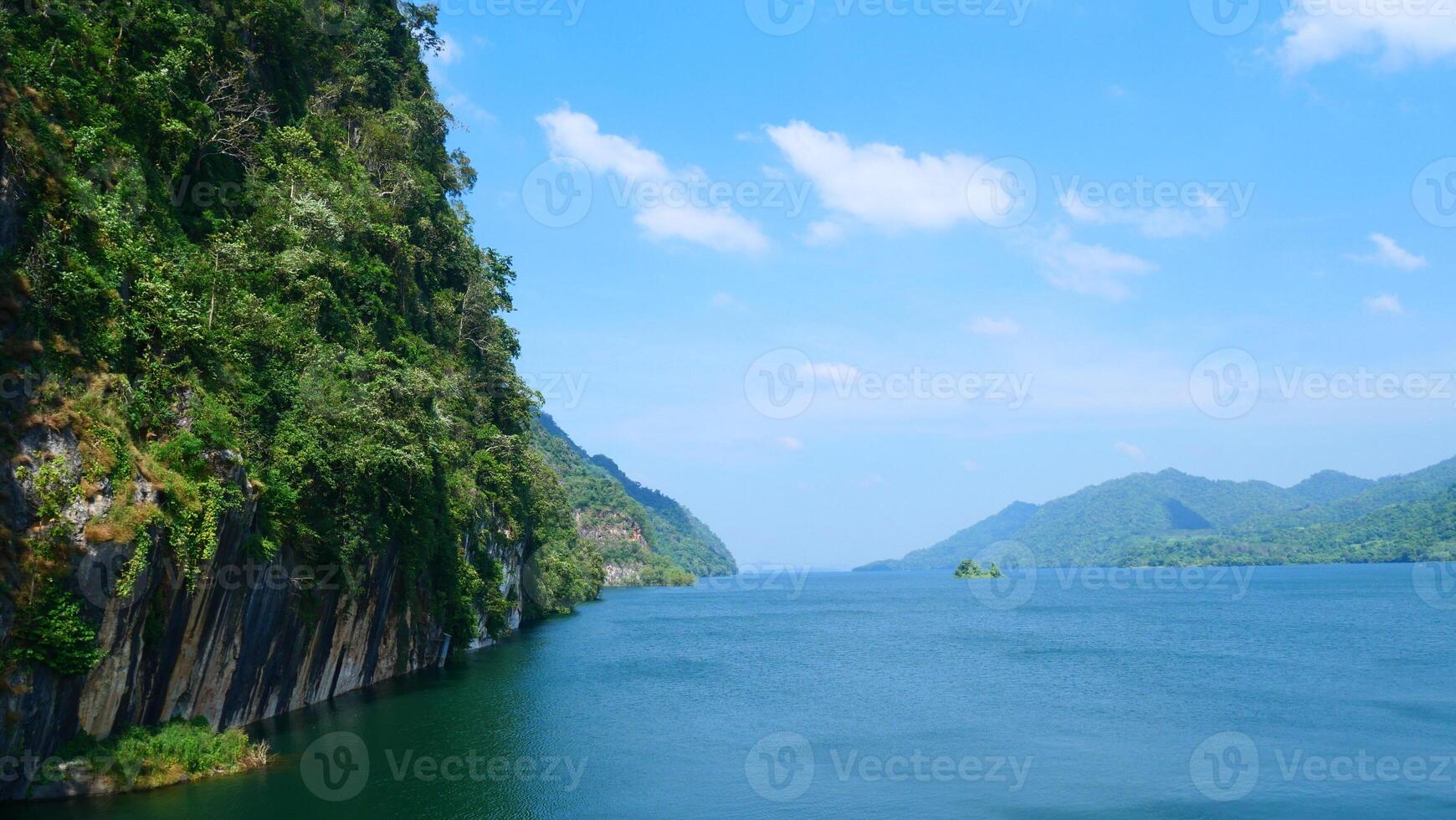 Blue water dam amidst mountains photo