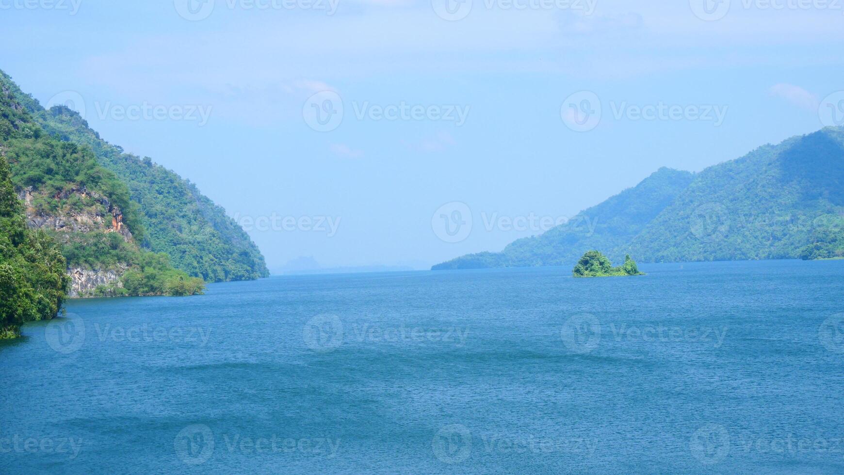 Blue water dam amidst mountains photo