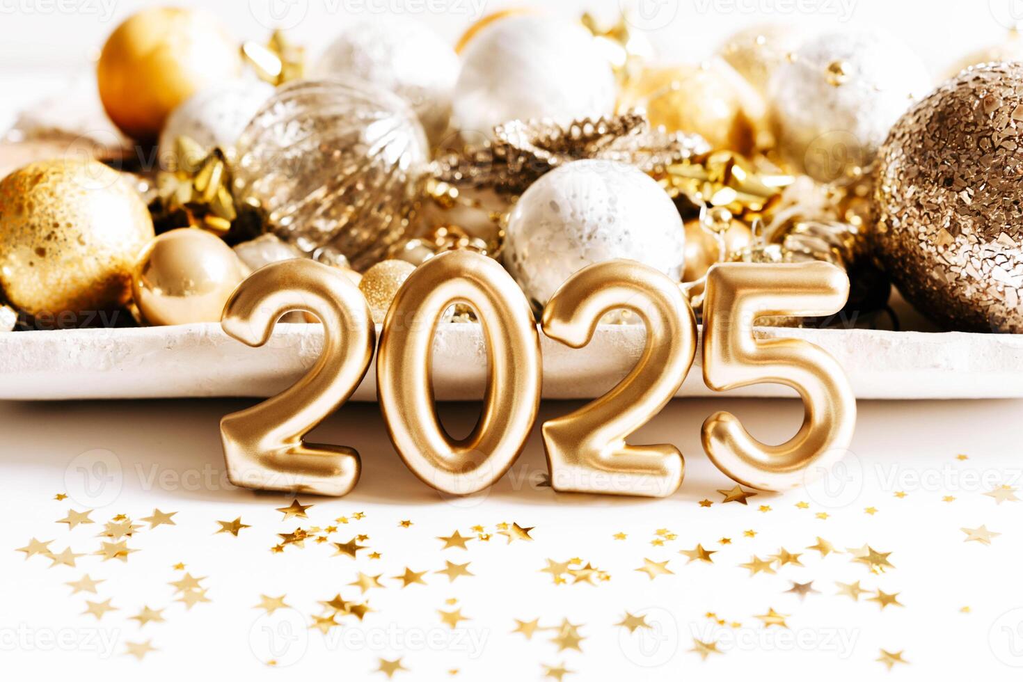 Celebratory front view design with golden 2025 numbers, near tray with festive decorations, gold star confetti photo