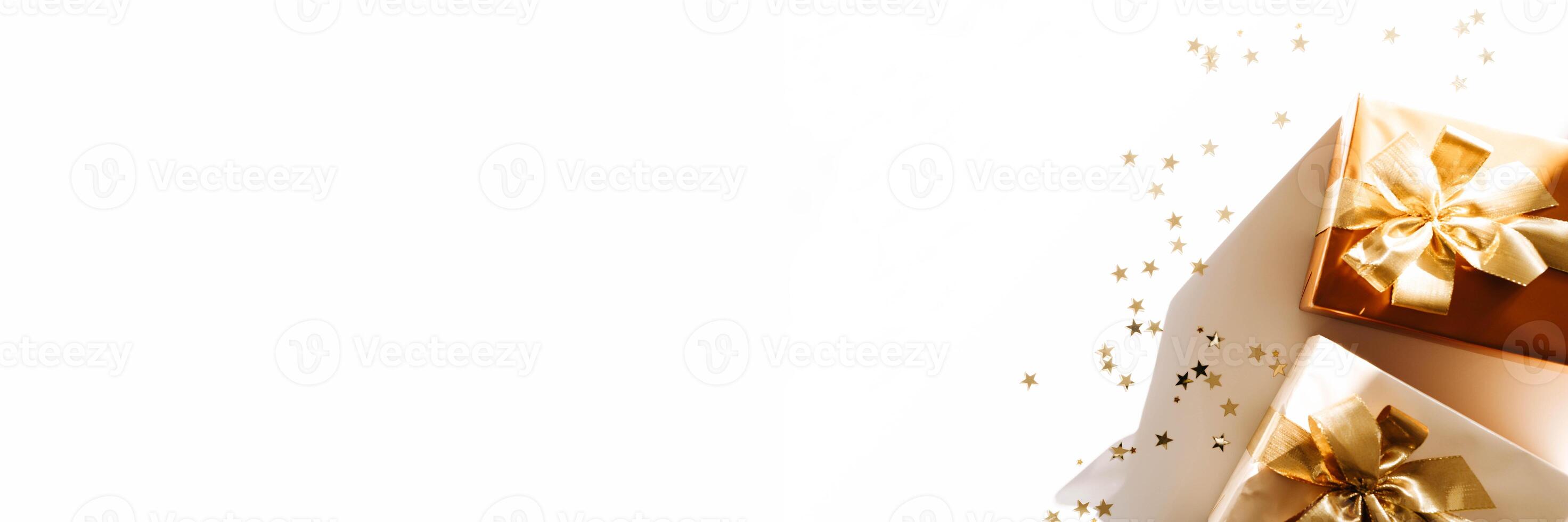 Banner with Christmas gift boxes, adorned with vibrant golden ribbons on white background with shadows photo