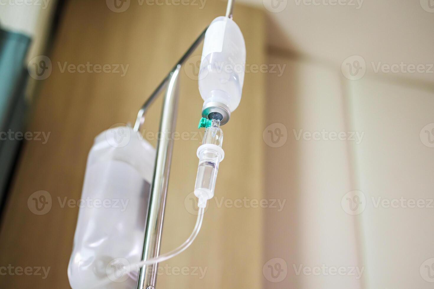 Close up medical intravenous IV drip in hospital background photo