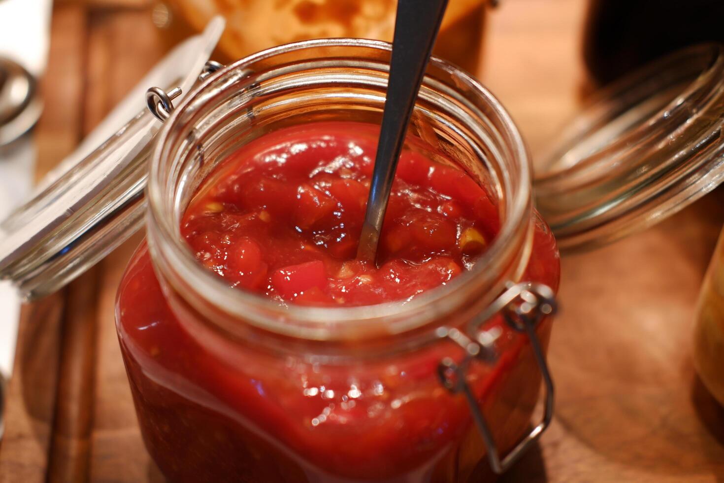pickles in a jar on a wooden table, close-up photo