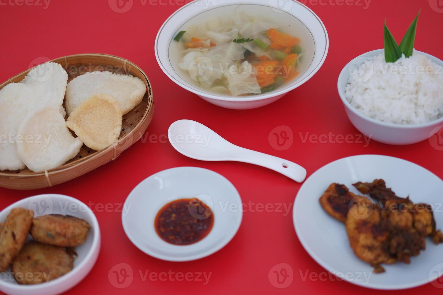 traditional Indonesian food arranged neatly on a red surface photo