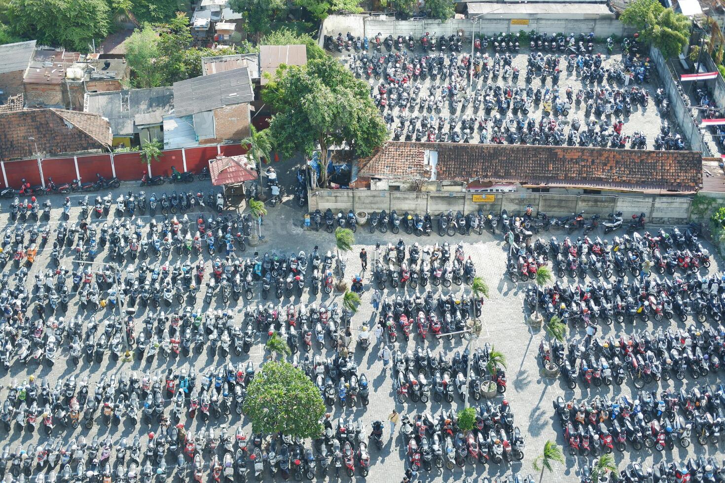 A large parking lot filled with rows of motorbikes photo