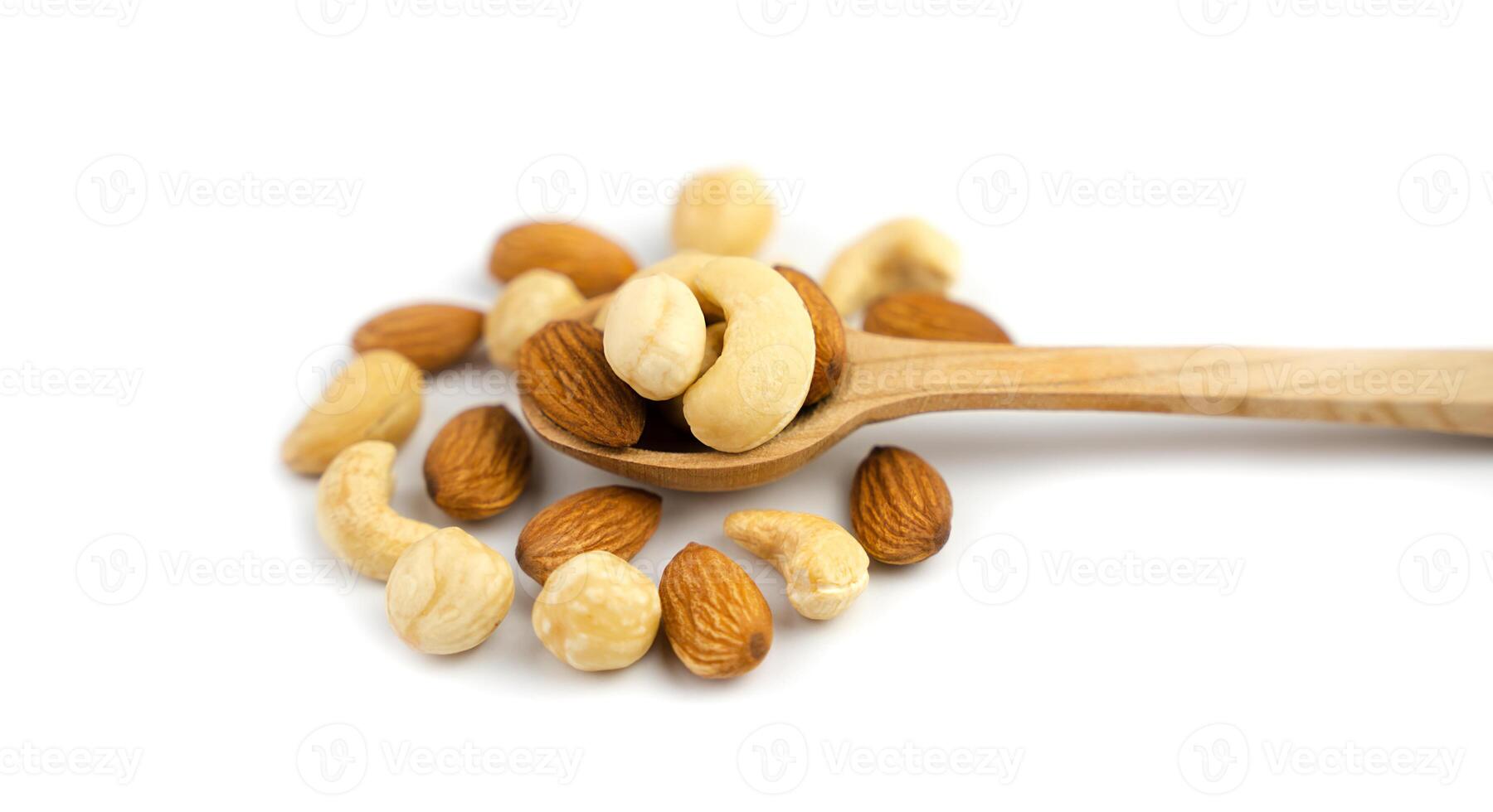 Mix of nuts in wooden spoon isolated on white background. Banner. Close-up. photo