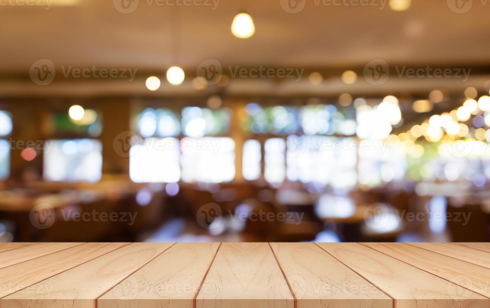 Empty wooden table top with lights bokeh on blur restaurant background. photo