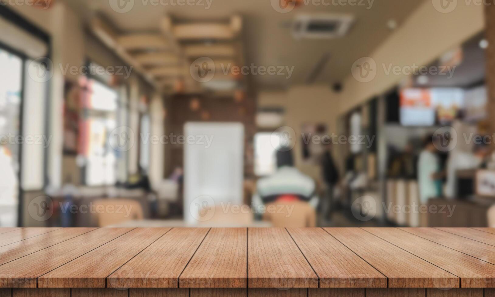 Empty wooden table top with lights bokeh on blur restaurant background. photo