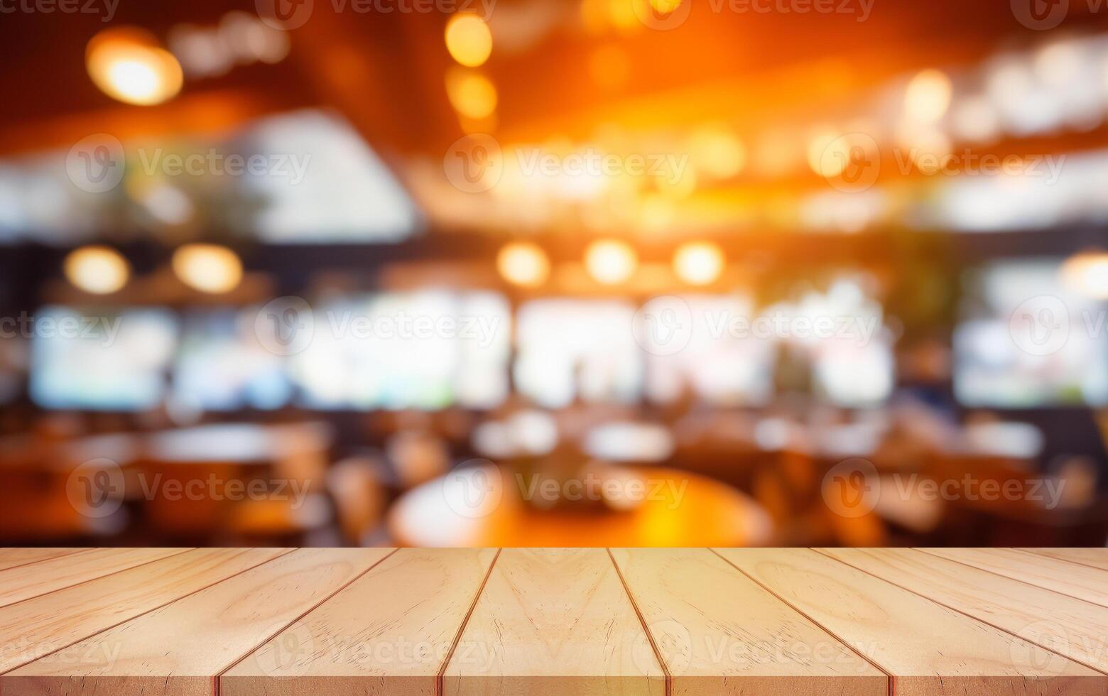 Empty wooden table top with lights bokeh on blur restaurant background. photo