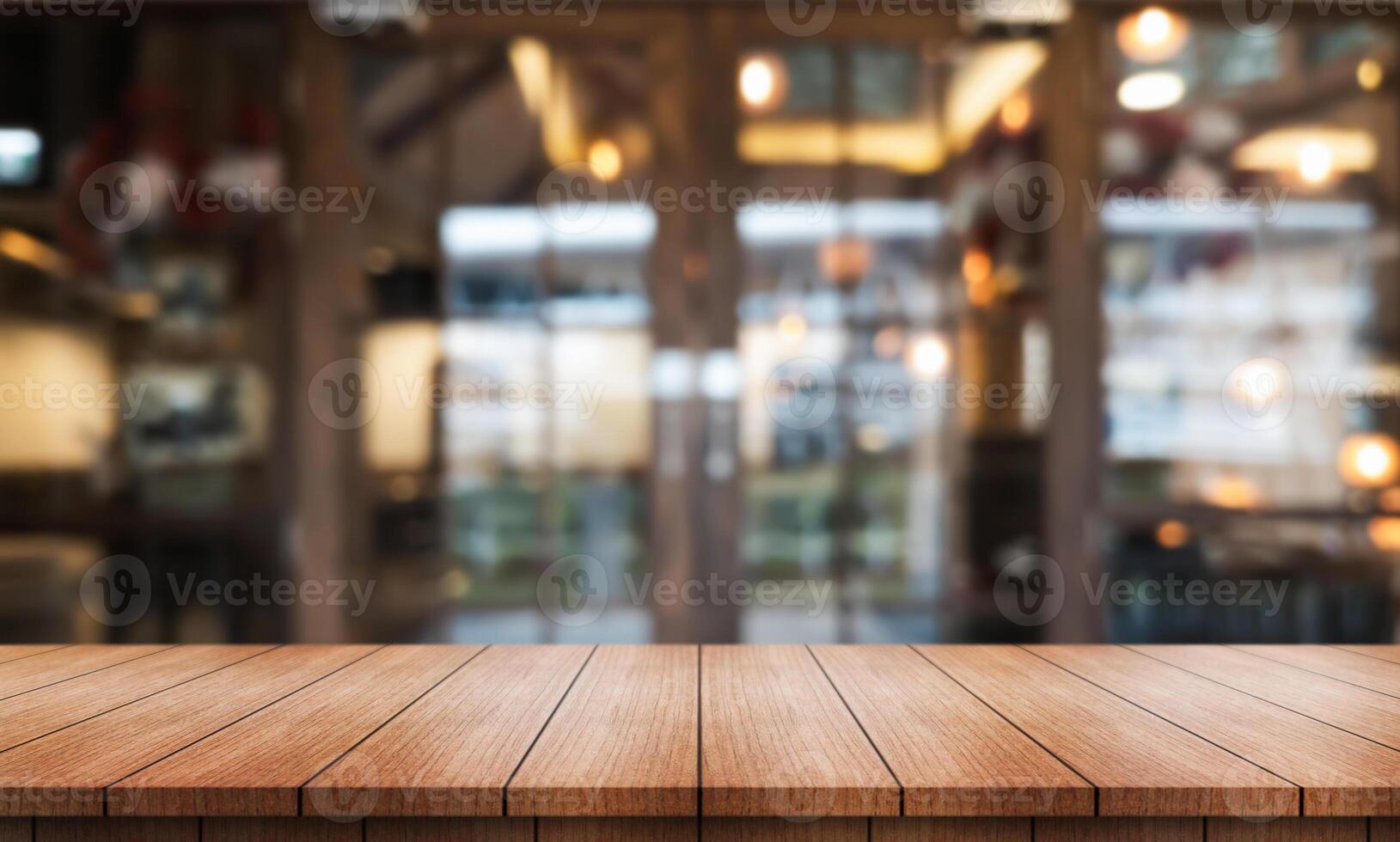 Empty wooden table top with lights bokeh on blur restaurant background. photo