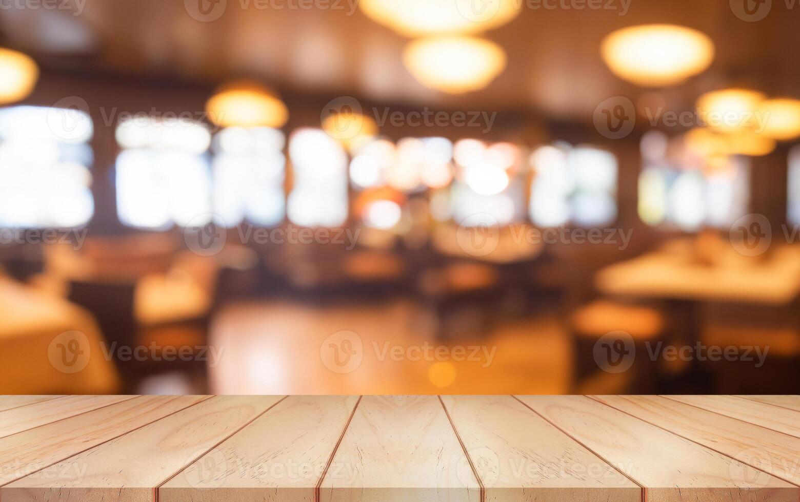 Empty wooden table top with lights bokeh on blur restaurant background. photo