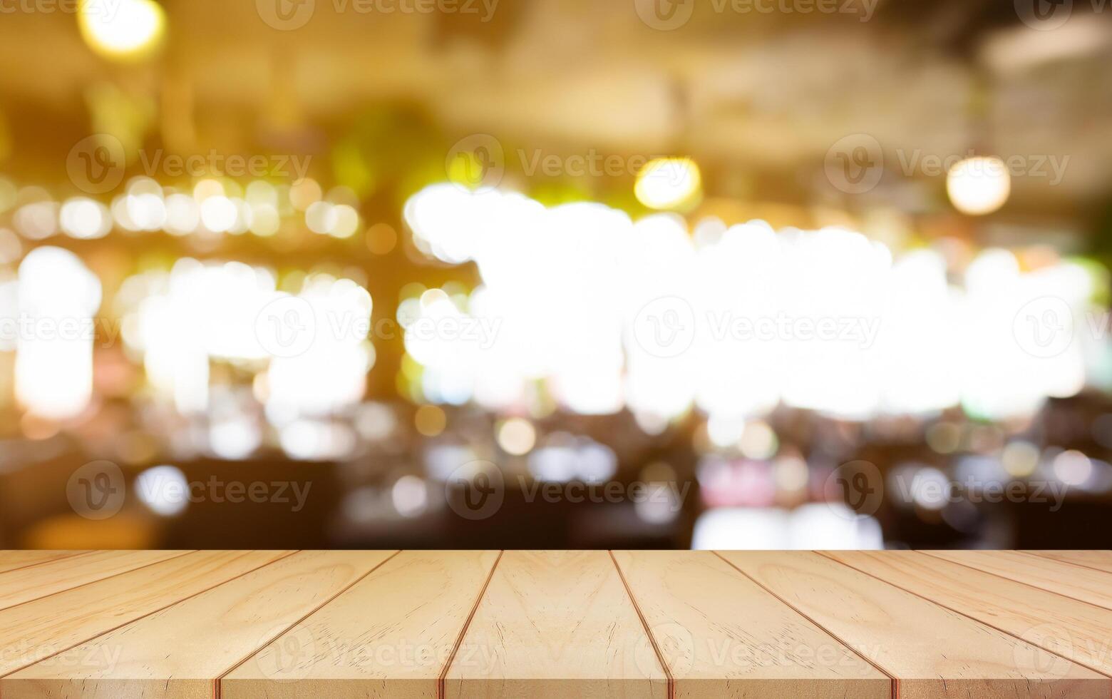 Empty wooden table top with lights bokeh on blur restaurant background. photo