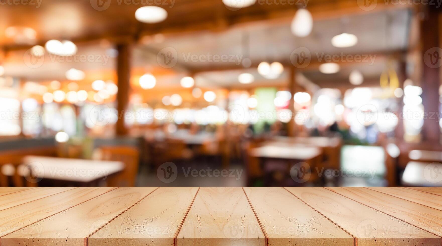 Empty wooden table top with lights bokeh on blur restaurant background. photo