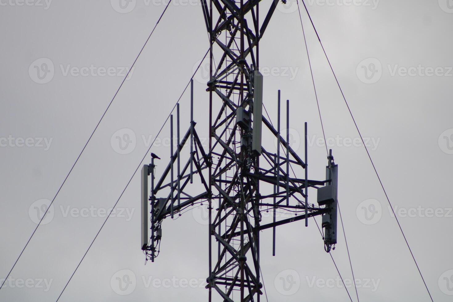 Telecommunications Tower High IN The Sky With A Cloudy Sky Background photo
