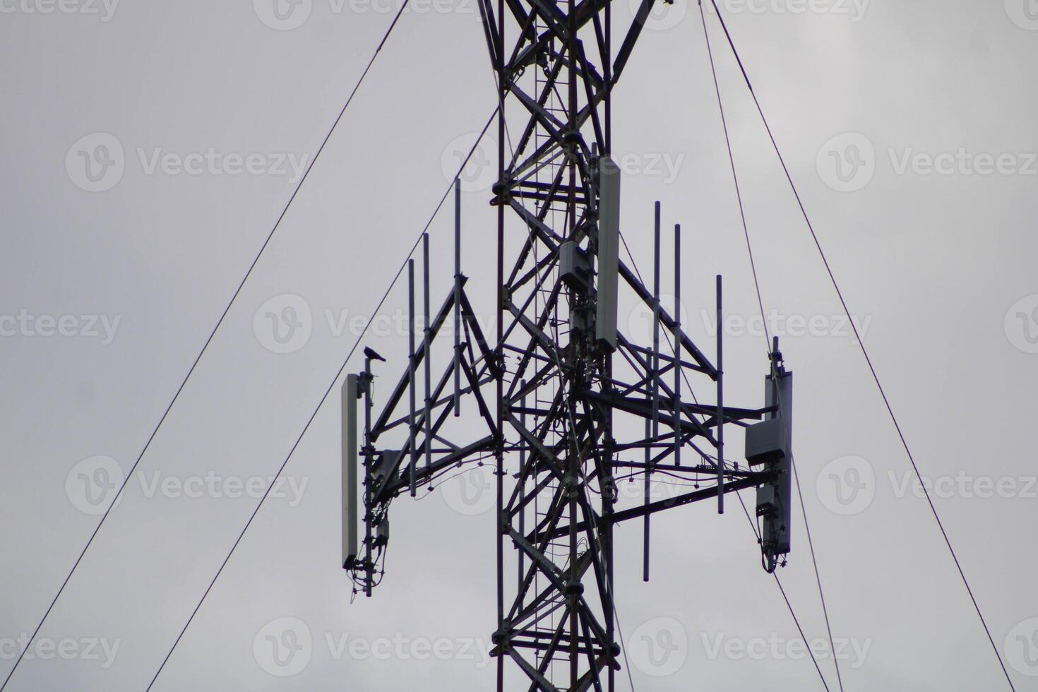 Telecommunications Tower High IN The Sky With A Cloudy Sky Background photo