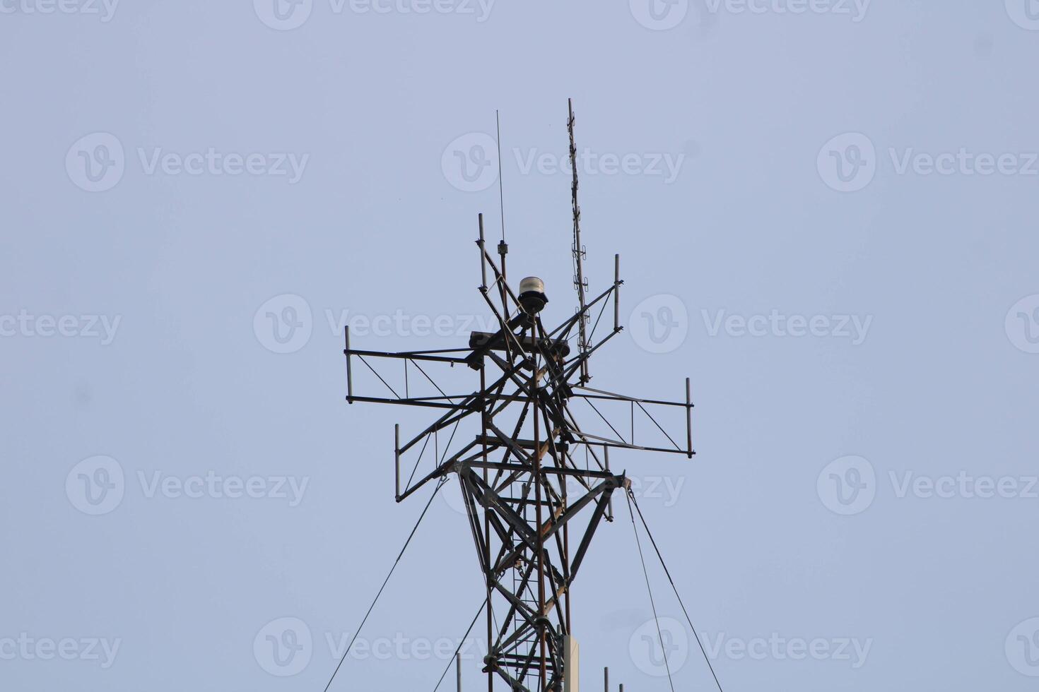 Telecommunications Tower High IN The Sky With A Cloudy Sky Background photo