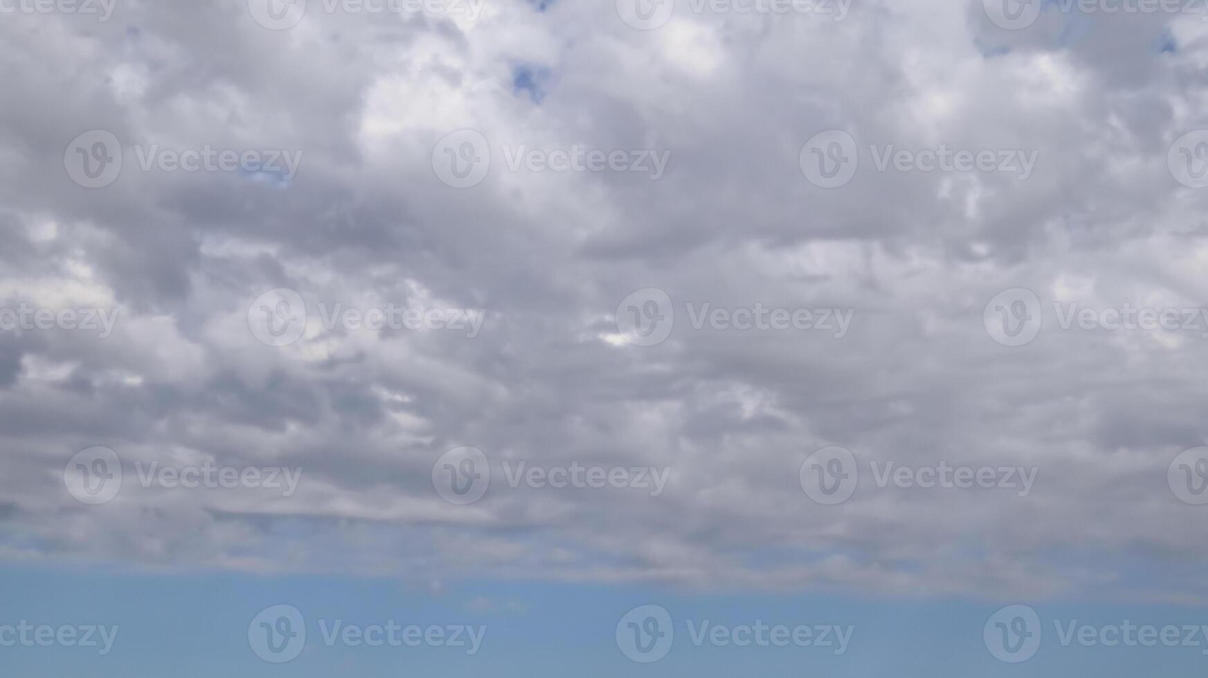 Beautiful dark dramatic sky with stormy clouds before rain or snow. Thunderstorm heaven landscape. Timelapse. photo