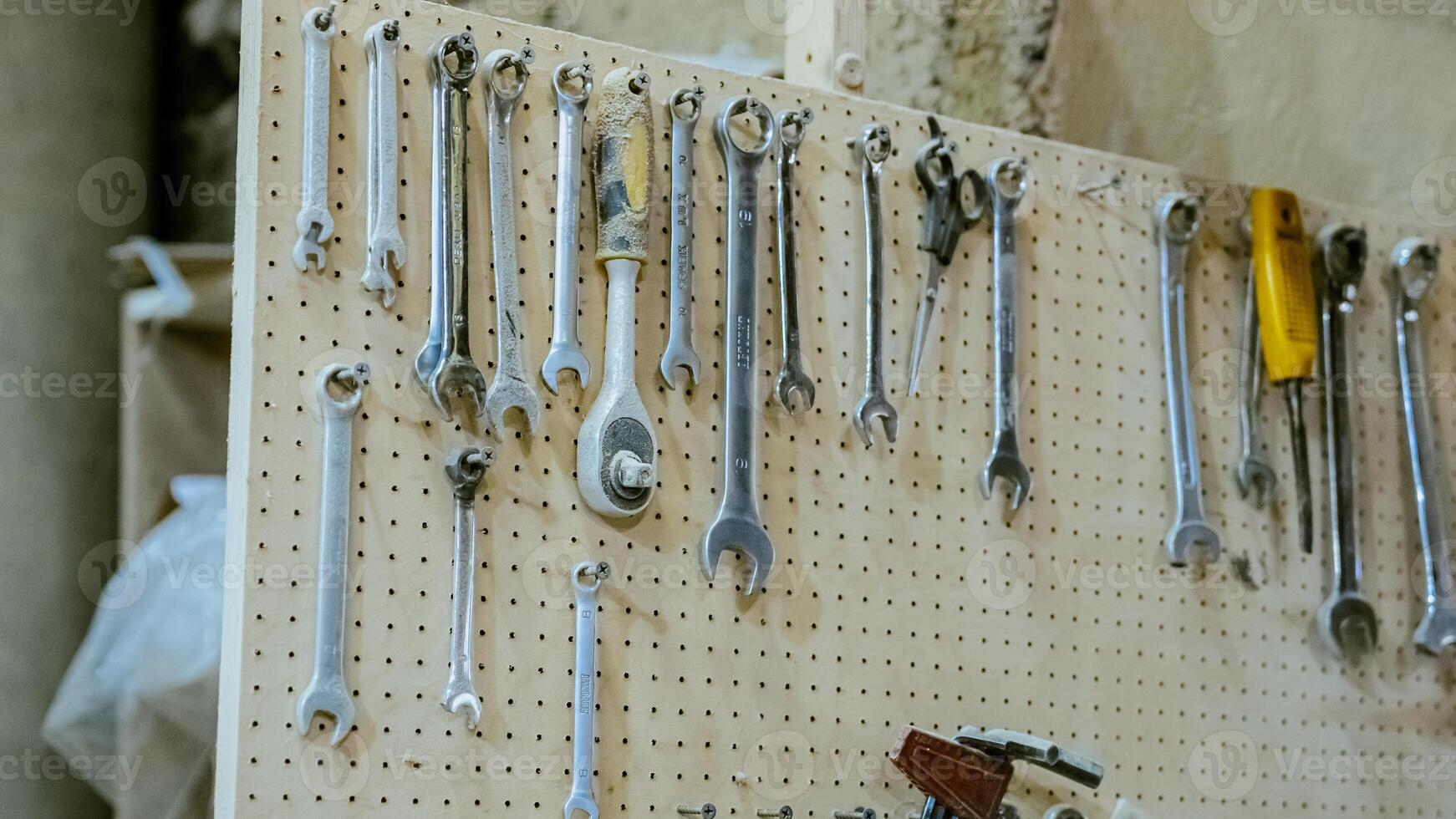 Various tools. file, screwdriver, hammer, pliers, garden tools are displayed on wooden shelf inside rustic garage or manufactory, workshop studio in a rustic garden house. Hobby, leasure activity. High quality photo