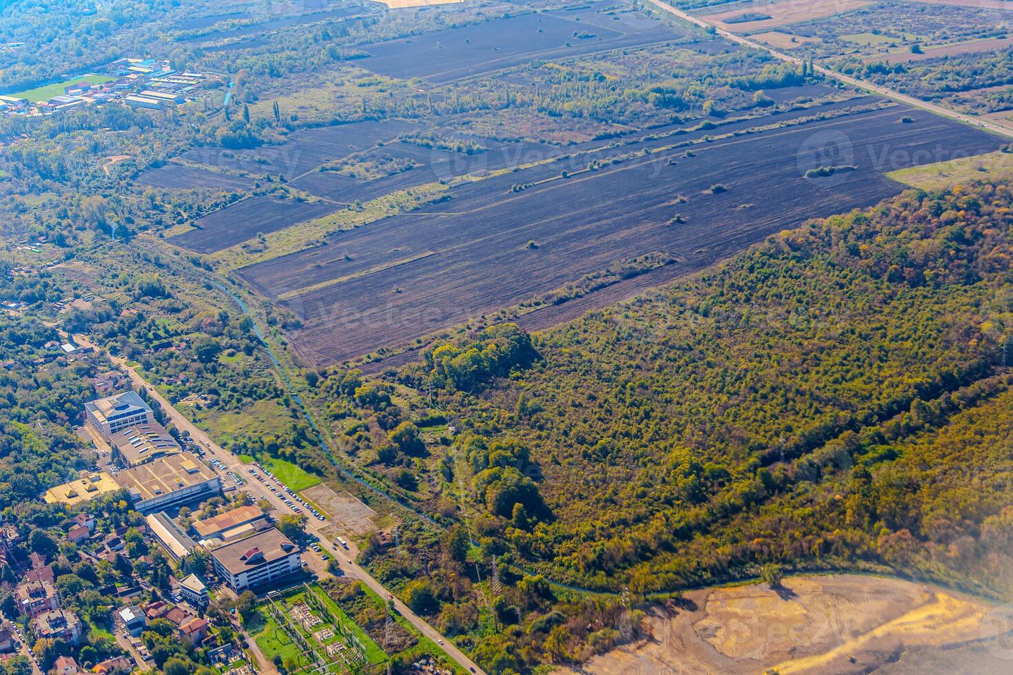 Aerial view of valley with farm fields, pond and Danube river. High quality photo