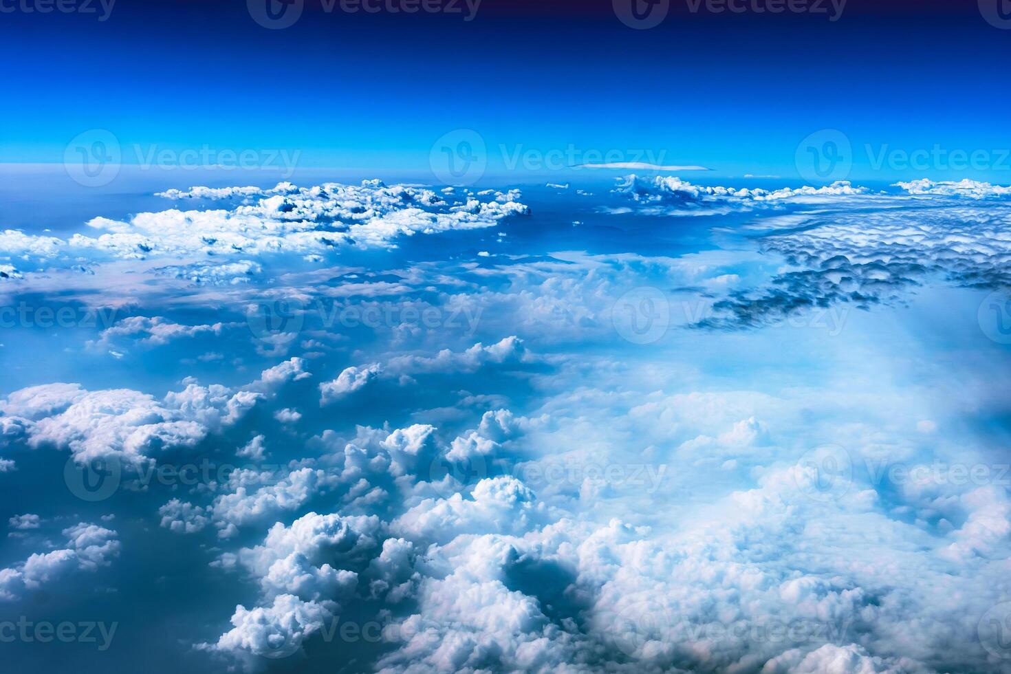 Aerial view from airplane window above green ground. View from the airplane window with beautiful clouds at sunrise. Earth and sky as seen through window of an airplane. photo