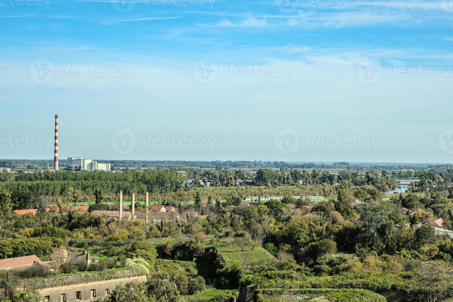 Agricultural fields with young green shoots of grain crops and plowed field without sowing. With trees in the background on the hills. Fallow concept. Alternation. photo