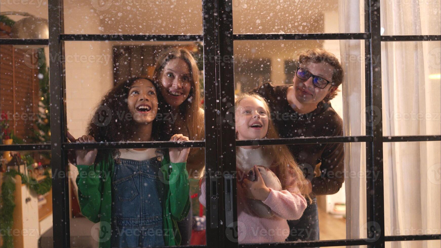 Parents and a teen girl on Christmas night with the first snowfall photo