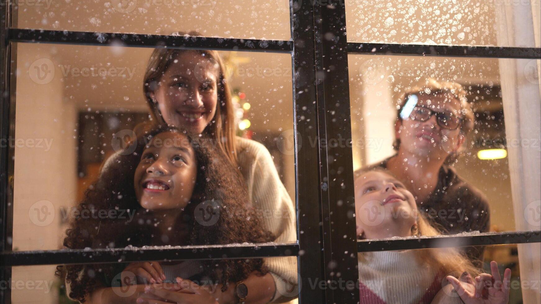 Parents and a teen girl on Christmas night with the first snowfall photo