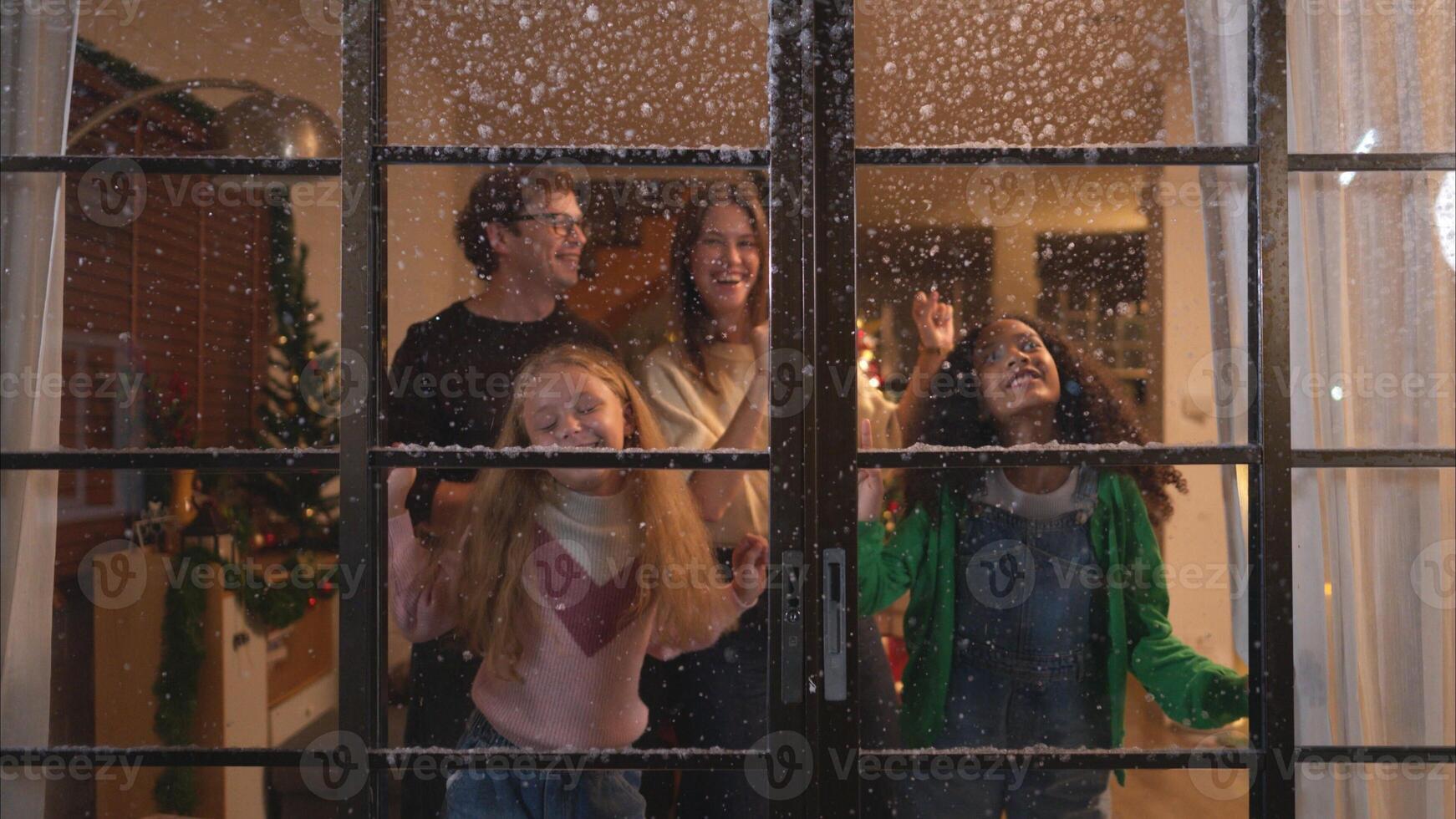 Parents and a teen girl on Christmas night with the first snowfall photo