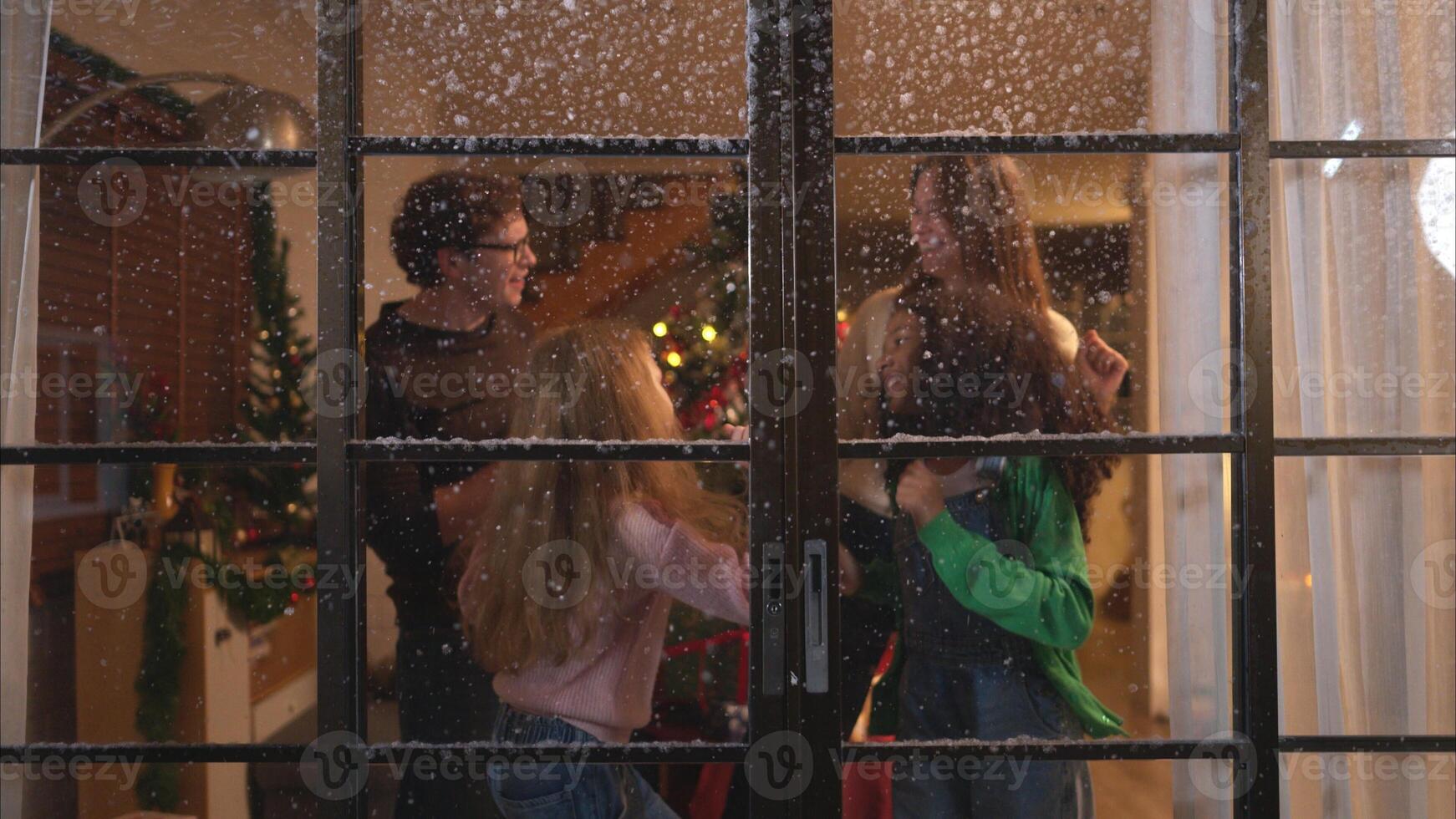 Parents and a teen girl on Christmas night with the first snowfall photo