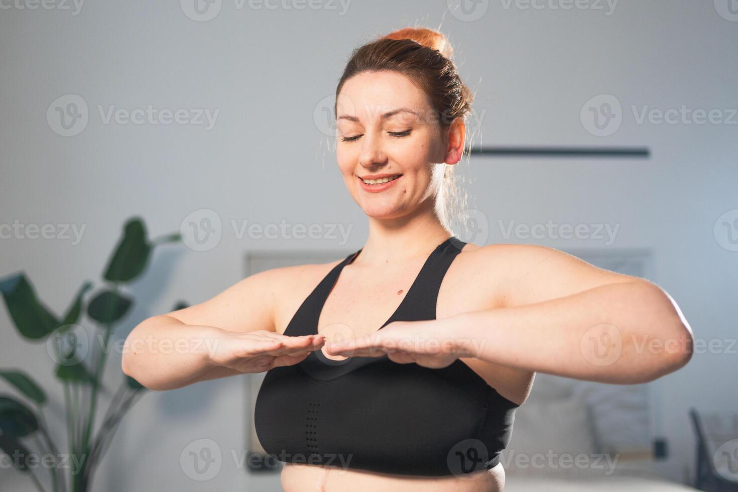 Fitness workout training. Woman practicing fitness at home. Plus size female doing sports exercise at home indoor. Girl in sportswear have workout weight training for weight loss. Sport and fitness photo