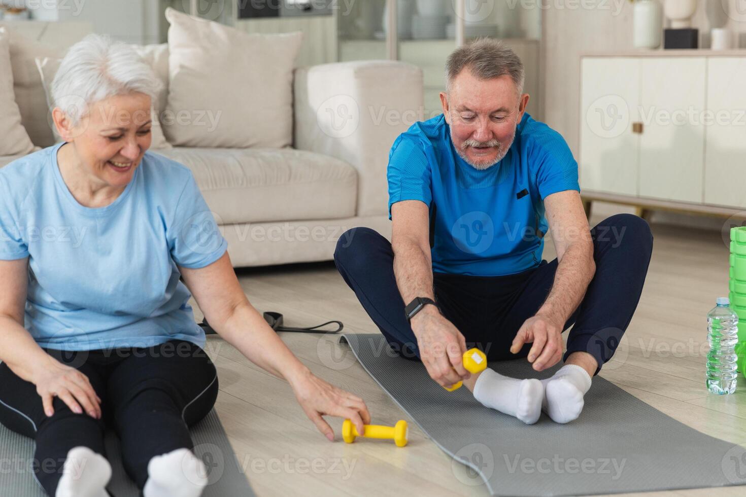 Fitness workout training. Senior adult mature healthy fit couple doing sports exercise on yoga mat on floor at home. Mid age old husband wife have training workout. Health care healthy lifestyle photo