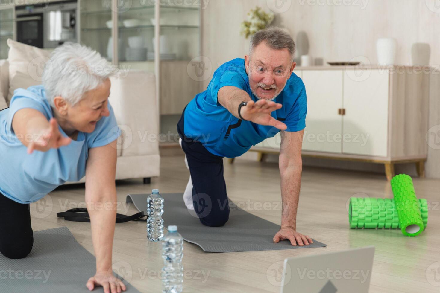 Fitness workout training. Senior adult mature healthy fit couple doing sports exercise on yoga mat on floor at home. Mid age old husband wife have training workout. Health care healthy lifestyle photo