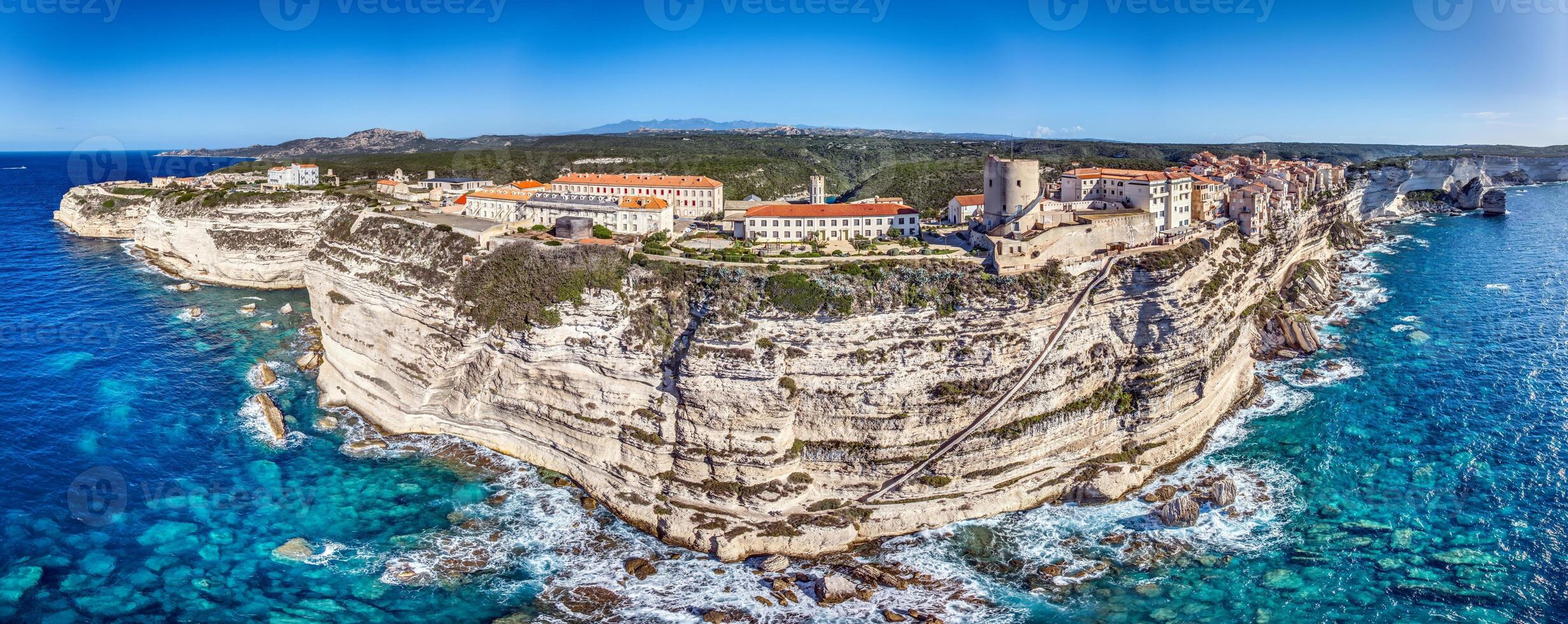 Aerial view of historic Bonifacio on Corsica, perched dramatically on limestone cliffs above the Mediterranean sea photo