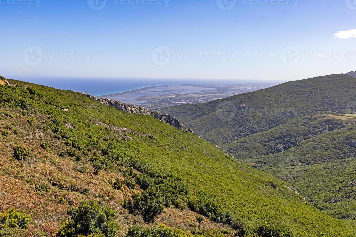 Panoramic view of Corsicas eastern coastline captured from the mountainous inland with lush greenery photo