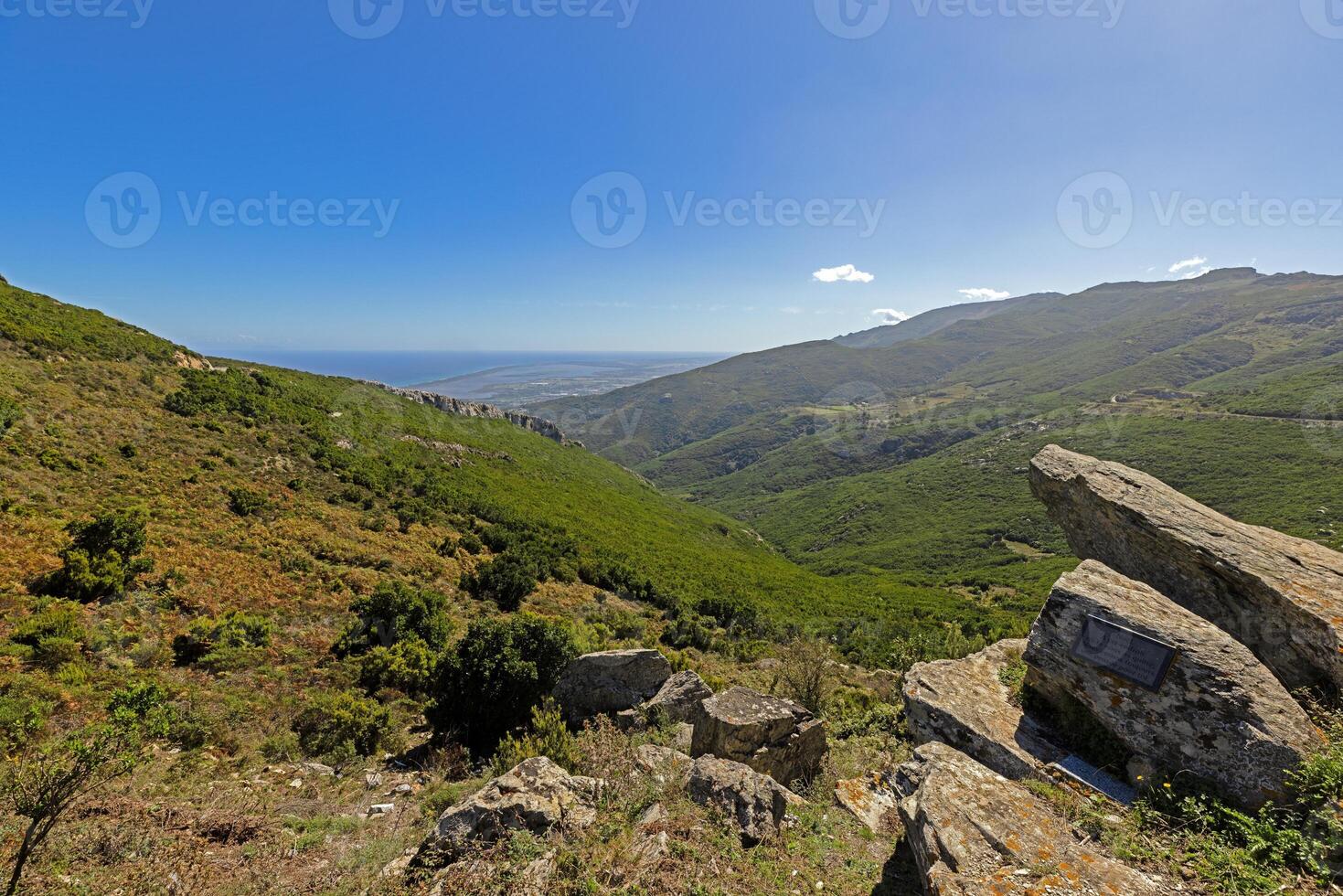Panoramic view of Corsicas eastern coastline captured from the mountainous inland with lush greenery photo