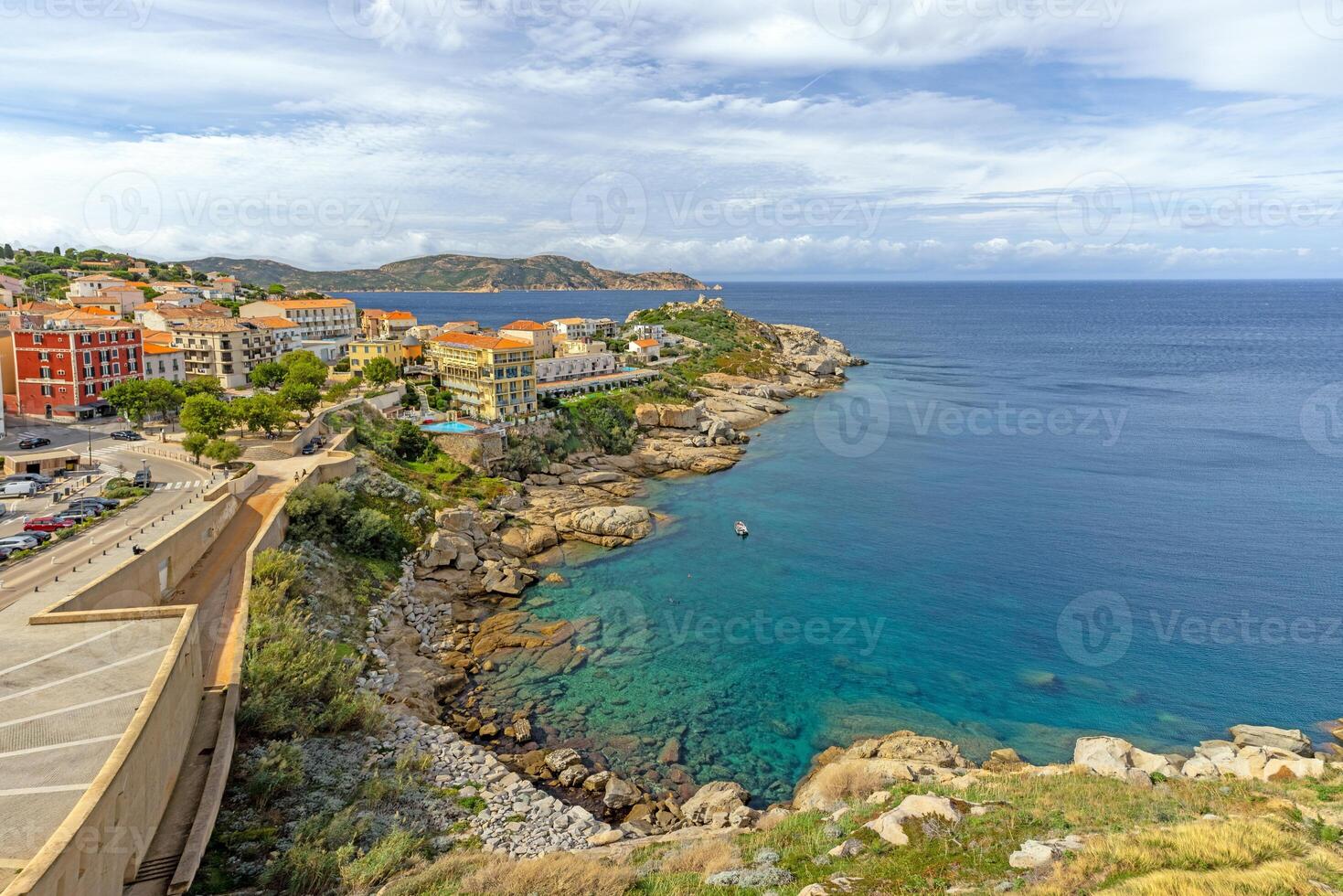 View from the fortress of Calvi in Corsica overlooking the coastline and the sea with mountains photo