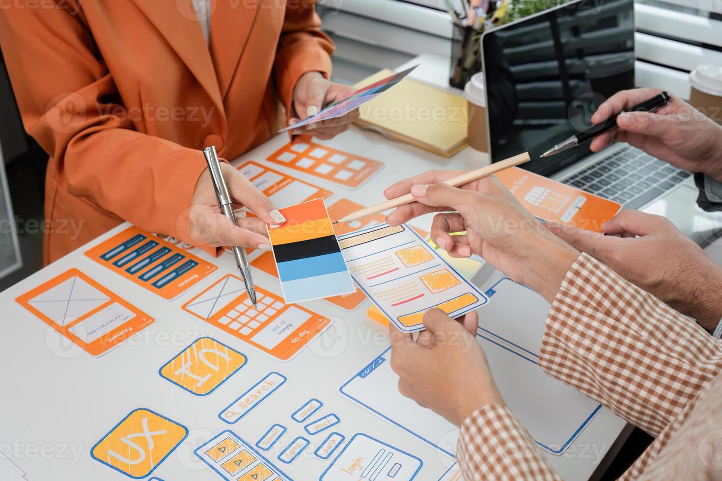 Creative Team Collaborates on UX UI Design Concepts with Wireframes and Prototypes in Modern Office Setting photo