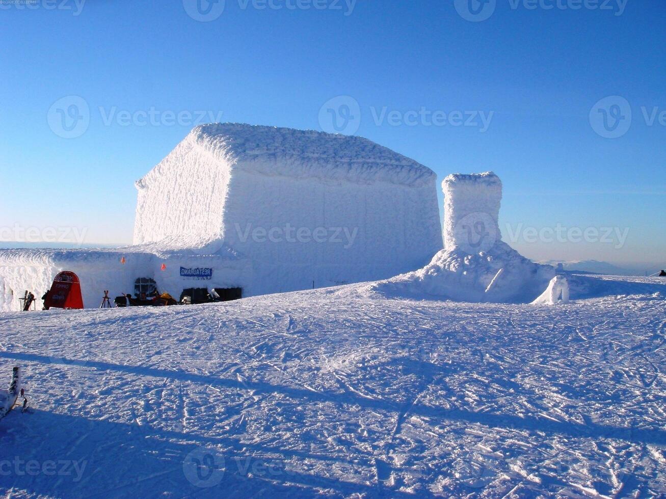 Snowy Slope with Ice Cap and Vehicle Under Sky photo