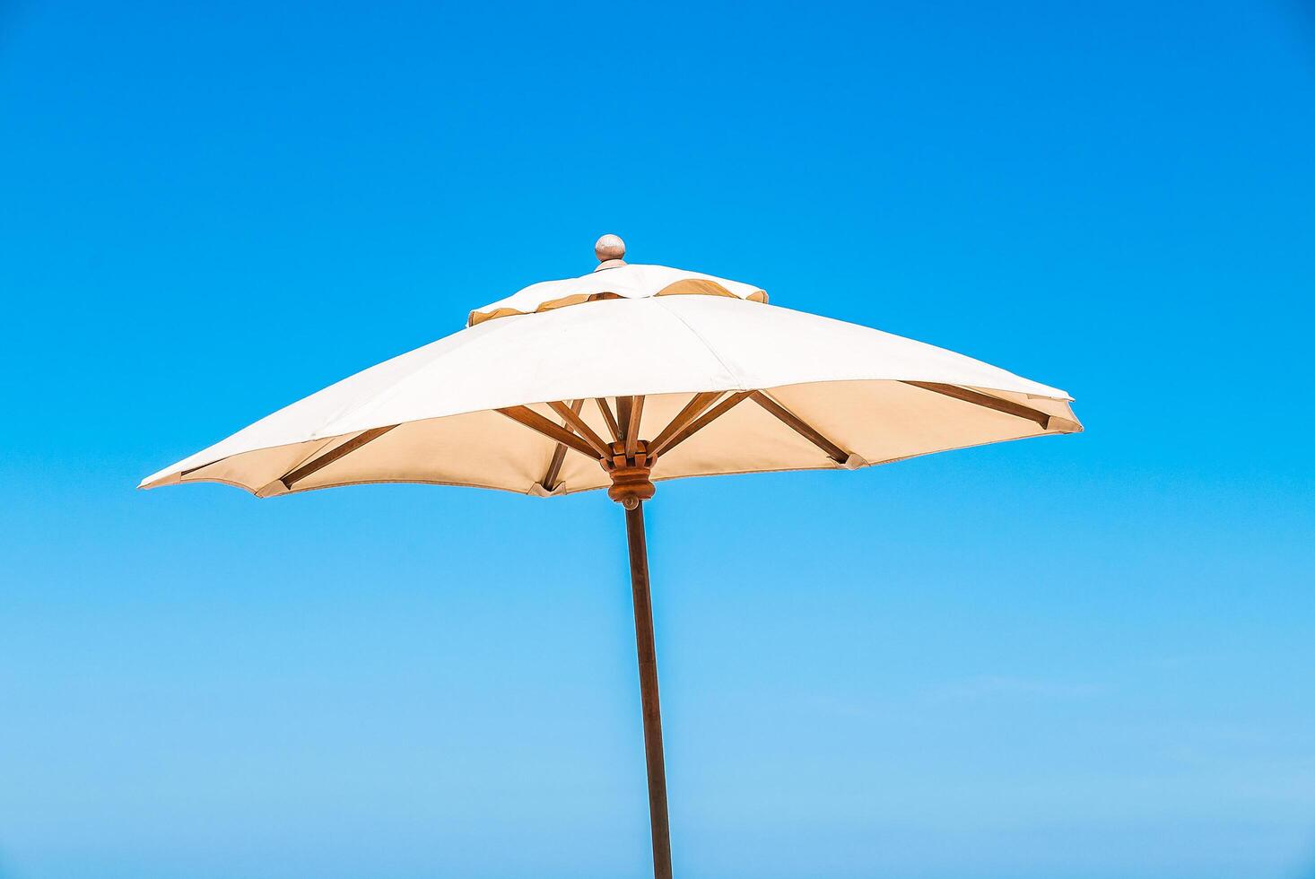 A white umbrella on a beach photo