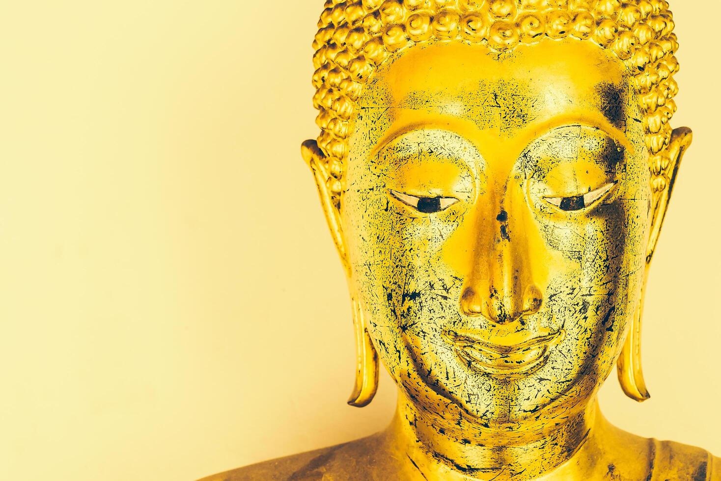 A golden buddha statue with a smile on its face photo
