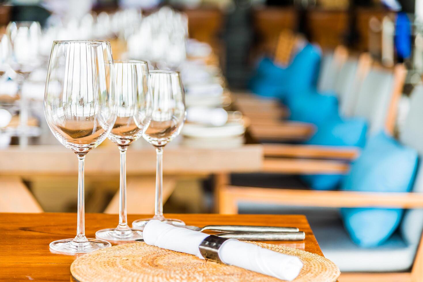 A table with several empty wine glasses and a place setting photo