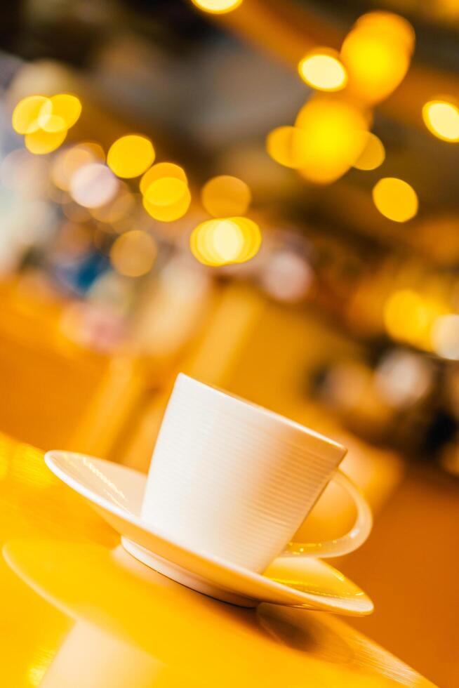 Coffee cup and saucer on a table in a restaurant photo