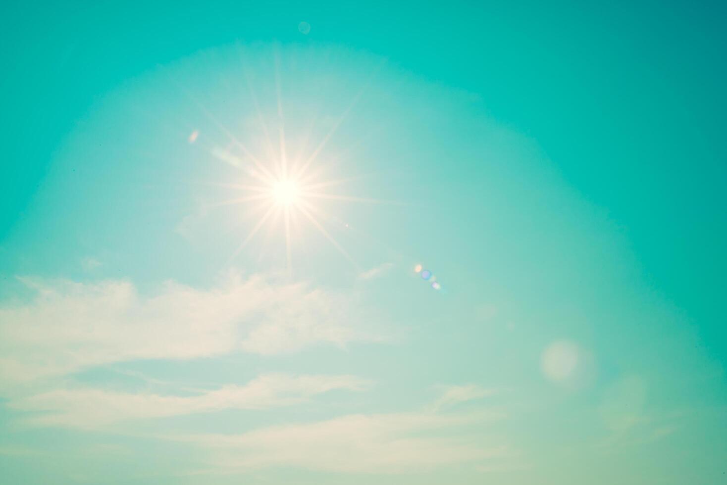 A person is standing on a beach with the sun shining photo
