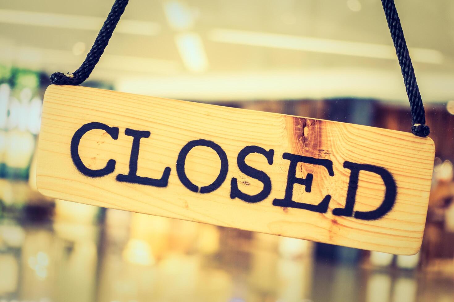 A closed sign hanging from a string photo