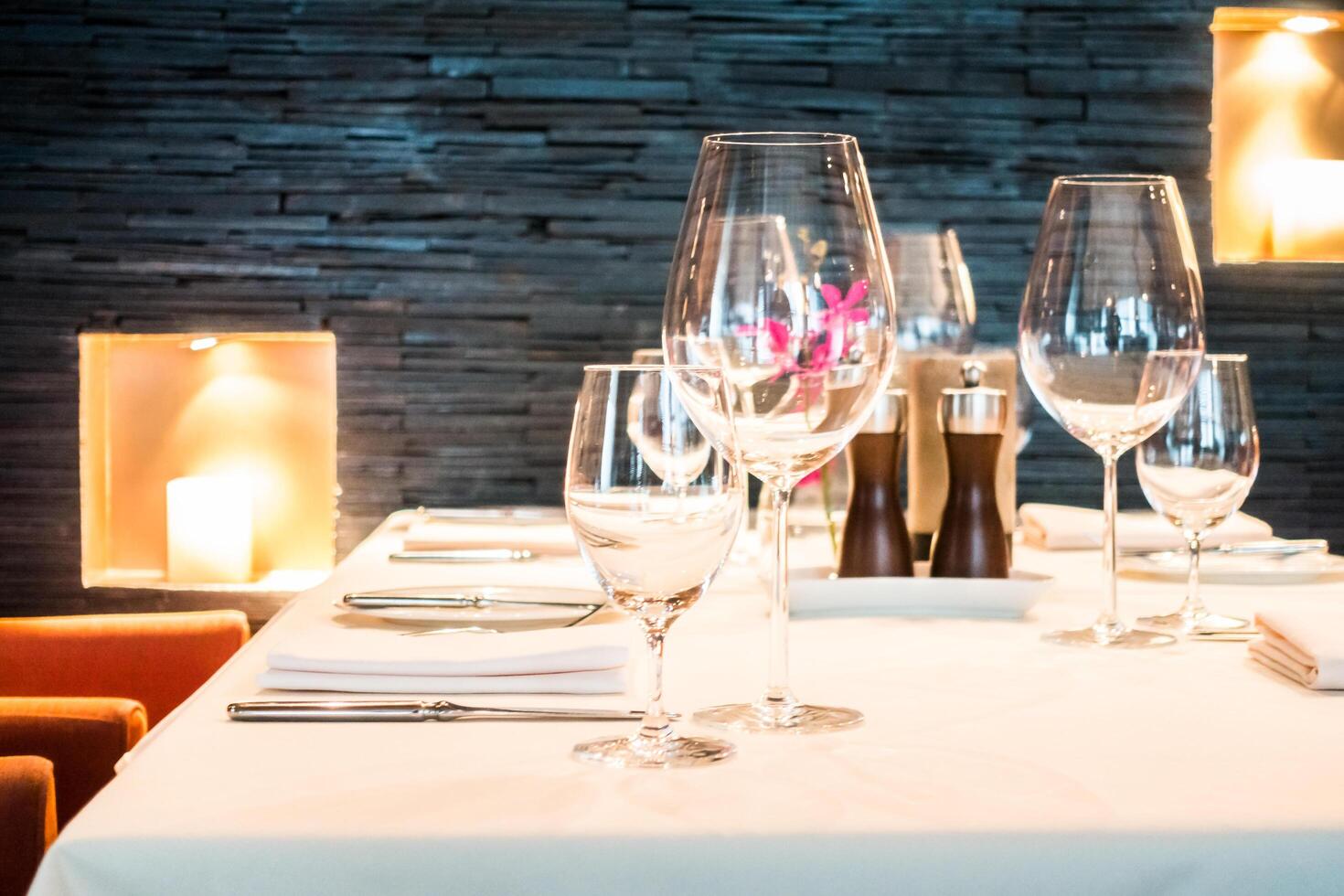 A table setting with wine glasses and place settings photo