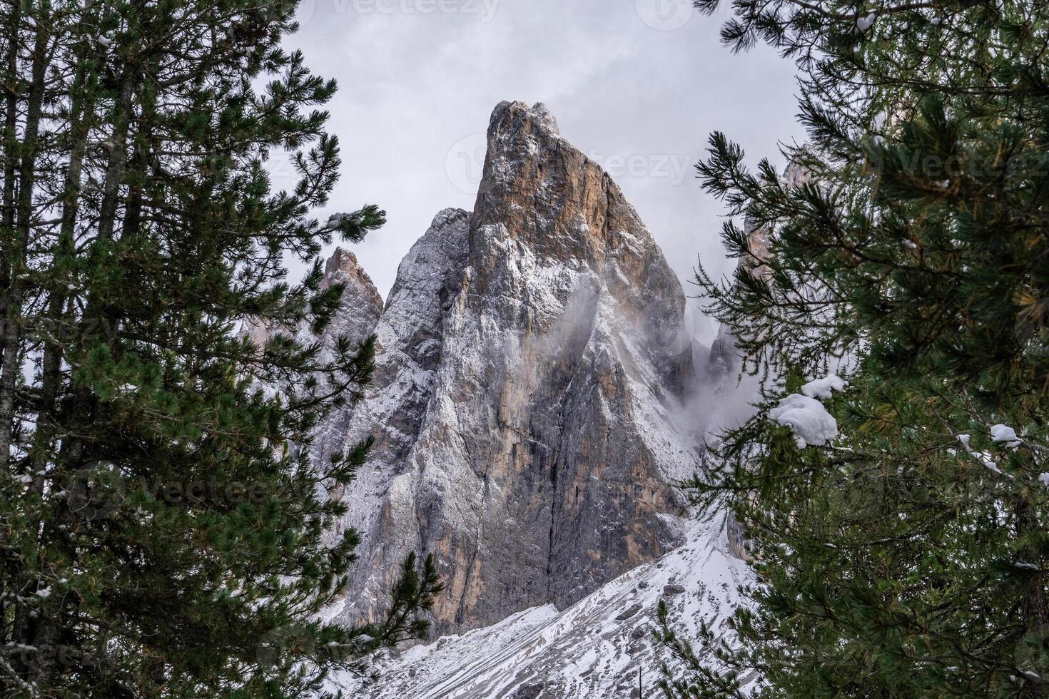 View of fog with mountain Geisler peaks in the Dolomites, Italy. photo