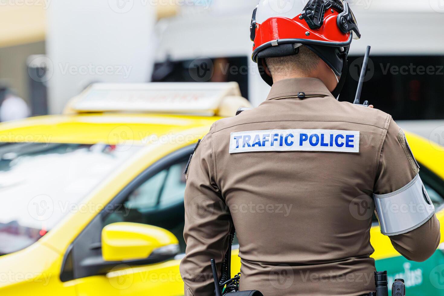 Thai traffic police officer working in busy road in Bangkok city metro operate solve traffic jam problem and public security photo