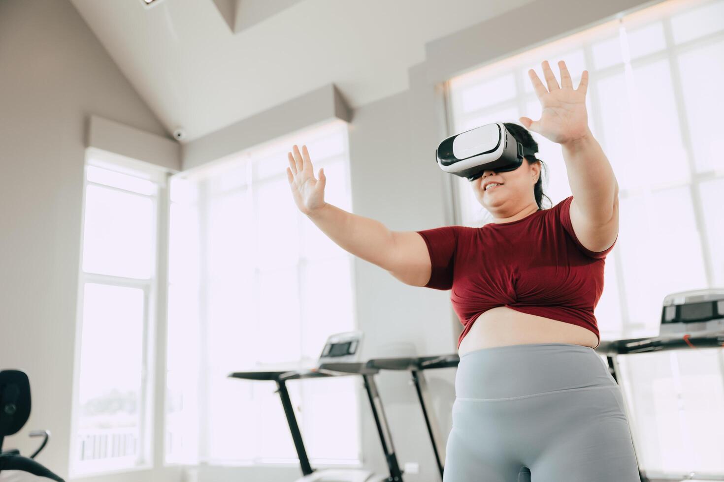 Woman Exercising with VR Headset on Treadmill in Gym photo