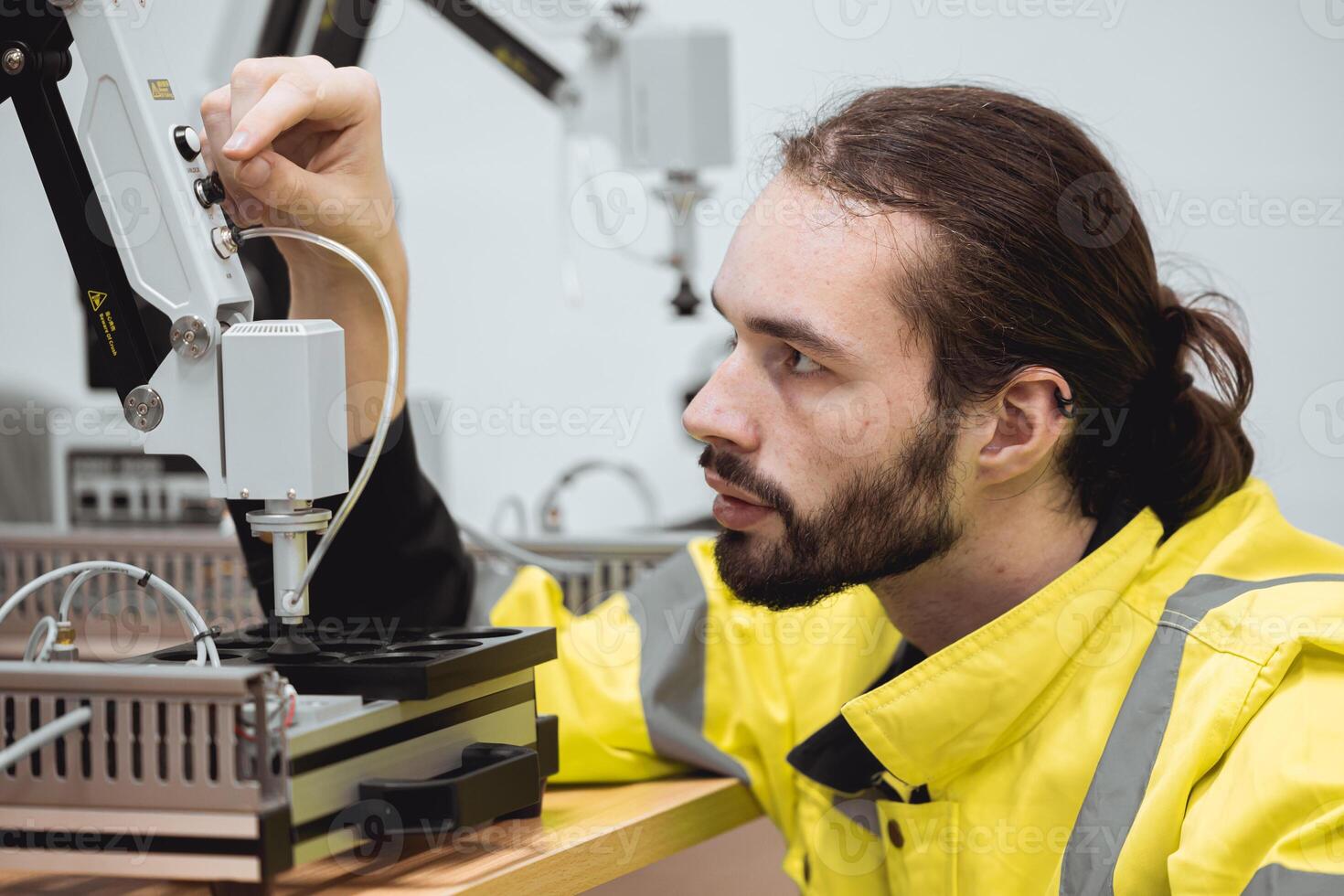 Engineer male education in Industrial Robotics program in university engineering lab classroom learning assembly robot mechanical arm. photo