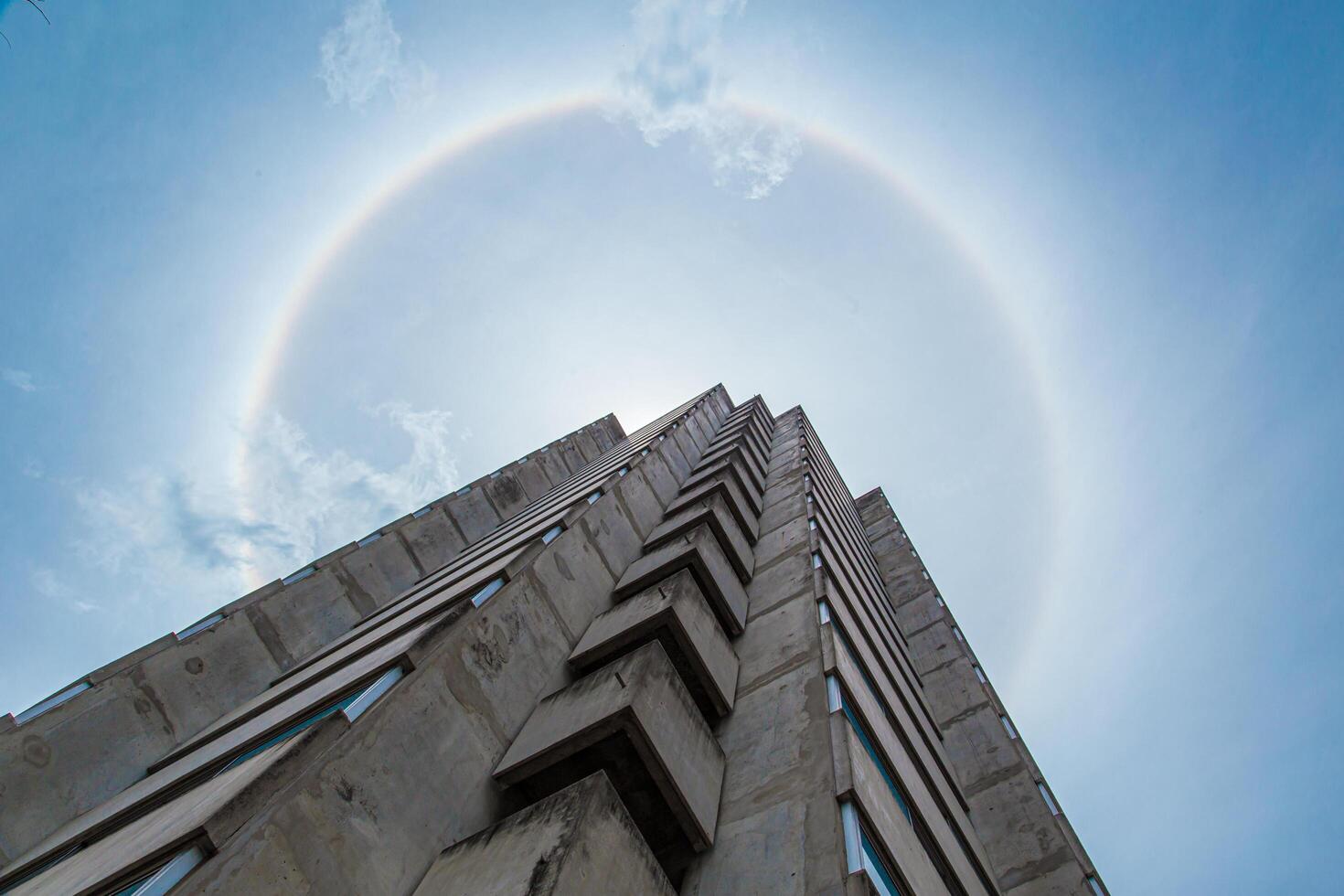 Sun Halo, Nature phenomenon of sunny light refraction with cloud to circle 360 degree rainbow with city building photo